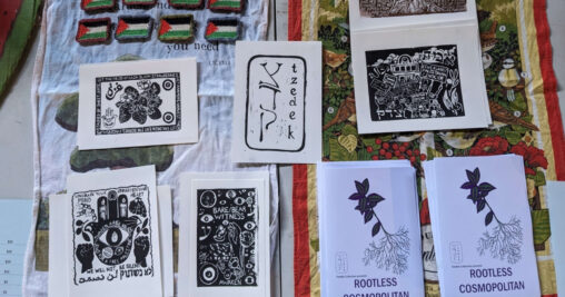 Tzedek Collective knitted Palestinian flag badges, linocut artwork and zines